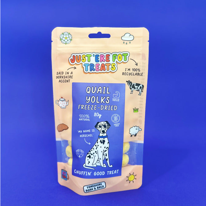 Front view of a packet / pouch of 'just'ere for treats' all natural freeze dried quail yolks on a plain blue background