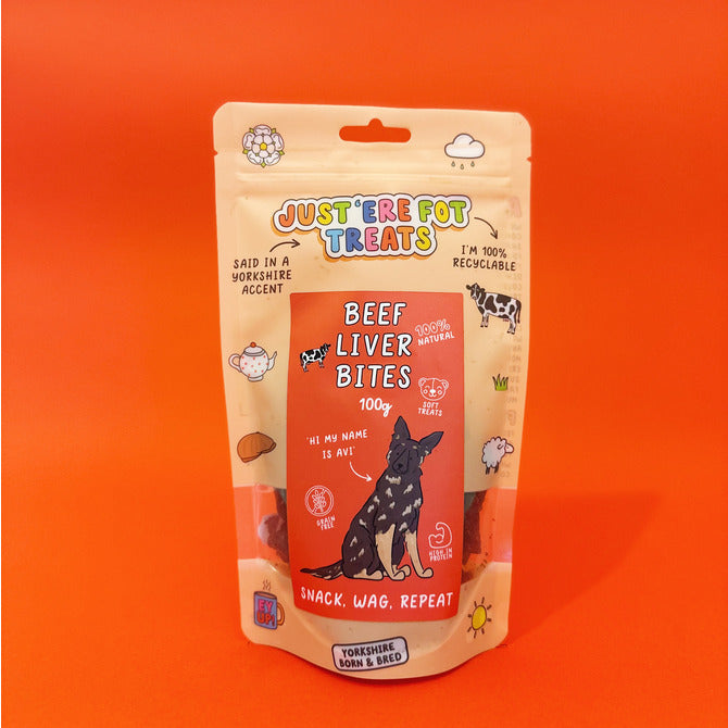 Front view of a packet/ pouch of 'Just'ere for treats' all natural backgroundeef liver bites on a plain orange/red background