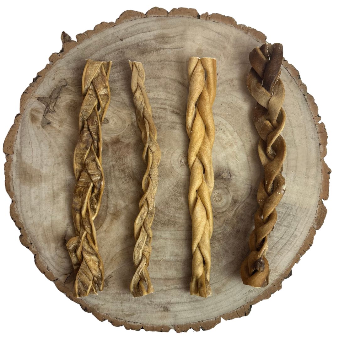 Four all natural dried braided beef skin on a wooden background