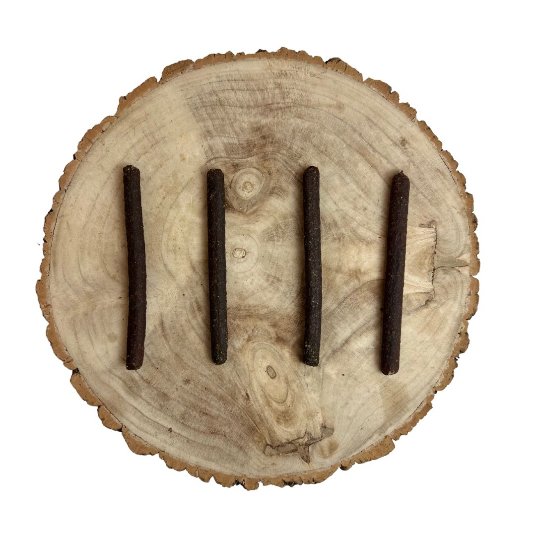 Four all natural liver meaty sticks on a wooden background