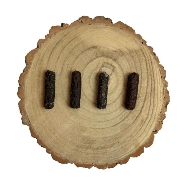 Four all natural dried venison small sausages on a wooden background