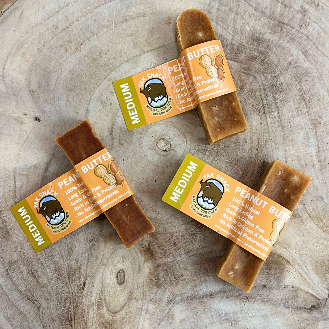 All natural medium yak milk chews penut butter flavour on a wooden background