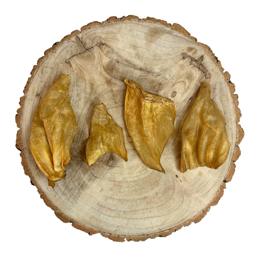 All natural cow ears on a wooden background