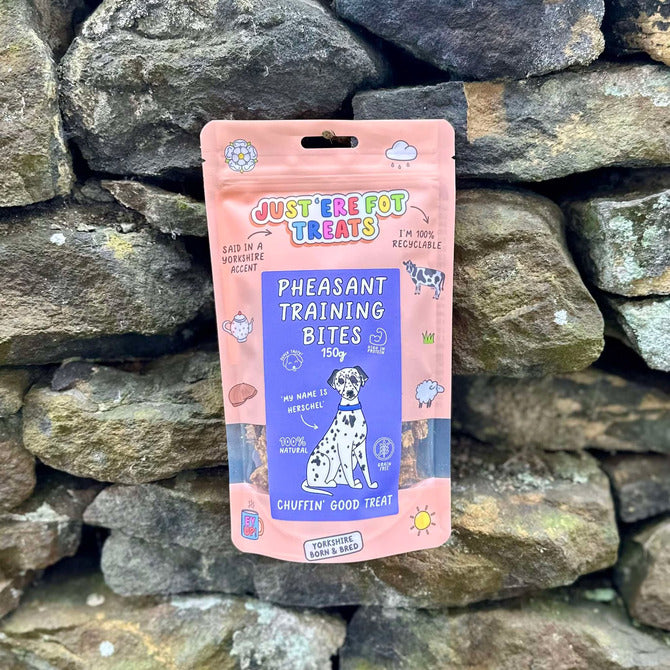 Front view of a packet/ pouch of just'ere for treats pheasant training bites on a stone wall background