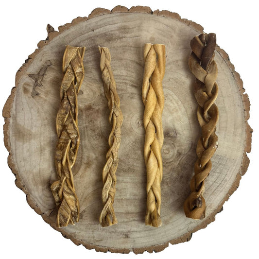 Four all natural dried braided beef skin on a wooden background