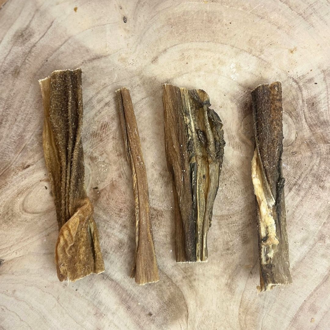 Four all natural dried beef tripe on a wooden background