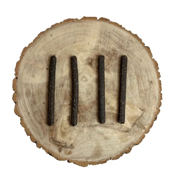Four all natural dried black pudding meaty sticks on a wooden background