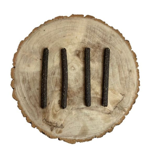 Four all natural dried black pudding meaty sticks on a wooden background