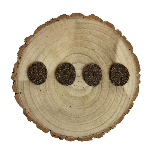 Four all natural dried venison burgers on a wooden background