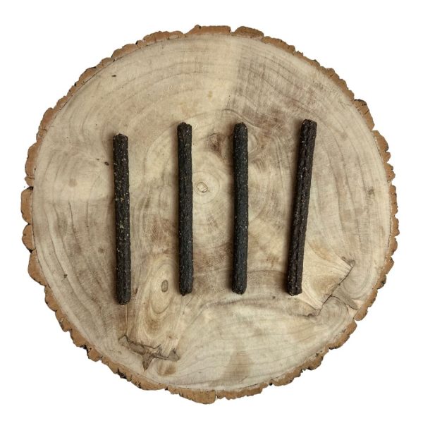 Four all natural dried chicken meaty sticks on a wooden background