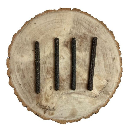 Four all natural dried chicken meaty sticks on a wooden background