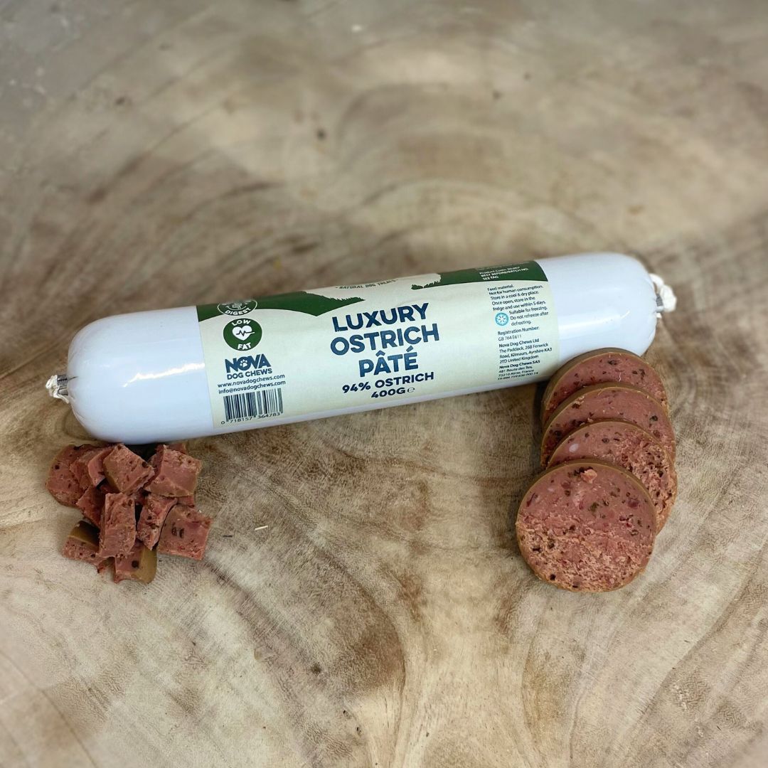 All natural luxury Ostrich pate in packet with cut discs and cubes in front on a wooden background 