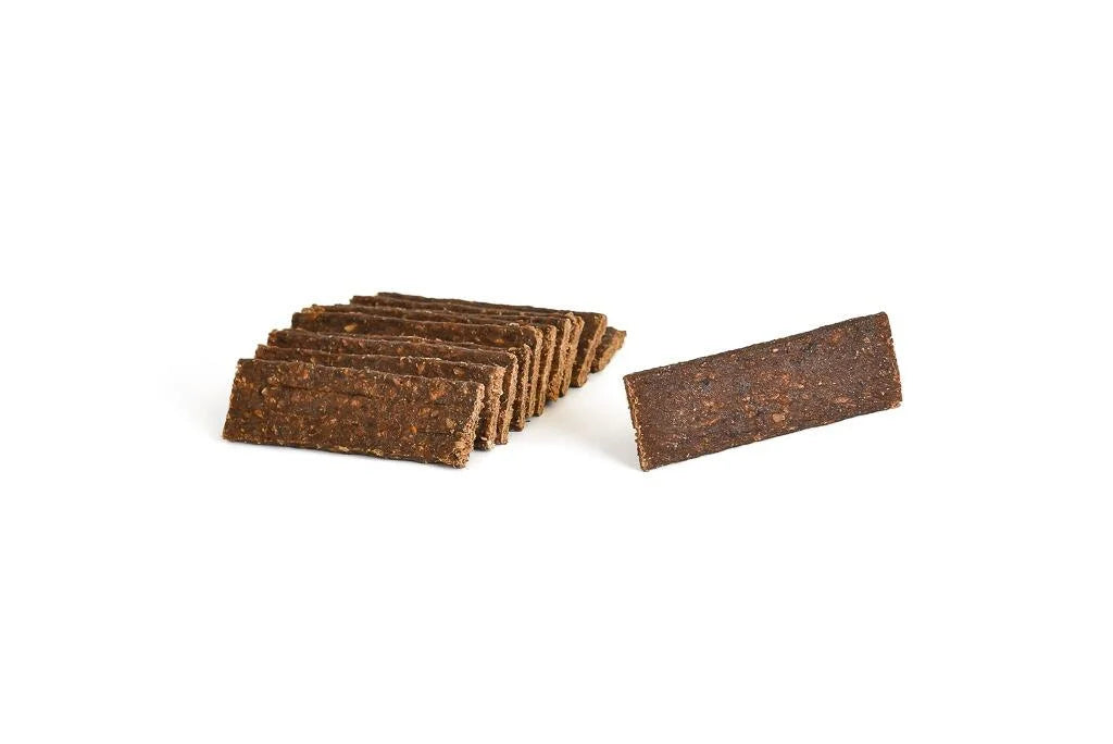 All natural dried duck meat strips on a white background