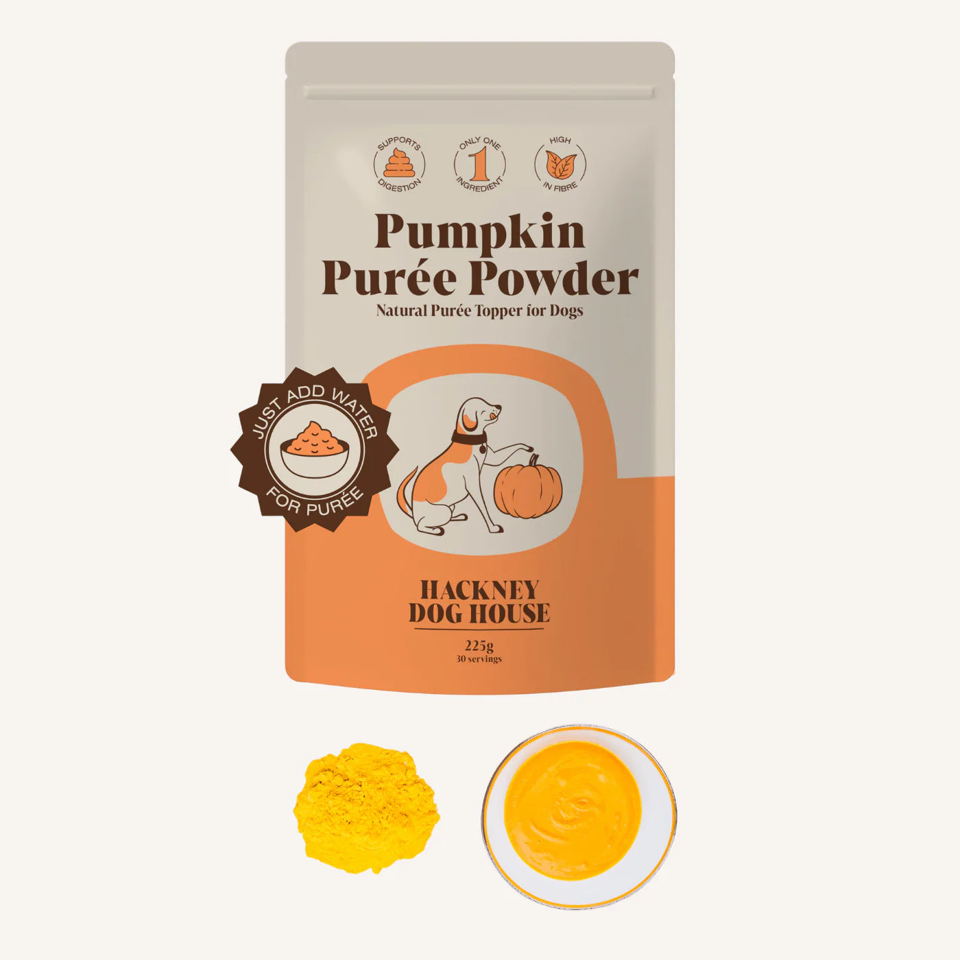 Front view of a packet/pouch of all natural pumkin puree powder for dogs on a plain white background. With a heap of the powder below to the left and a circle of the purre to the right below. 