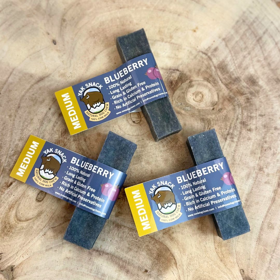 All natural medium yak milk chews Blueberry flavour on a wooden background 