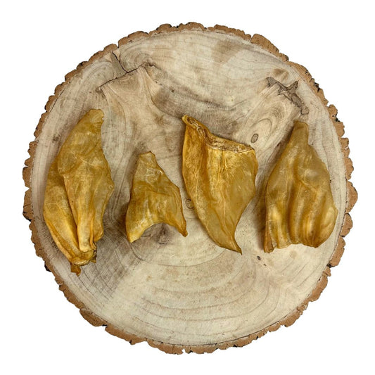 All natural cow ears on a wooden background